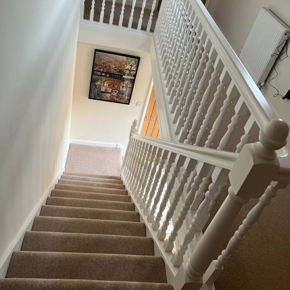 Before: white painted spindle staircase