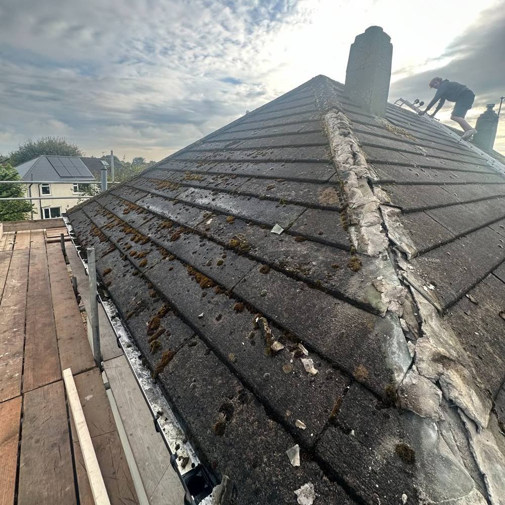 Before: old mossy hipped roof with damaged ridge