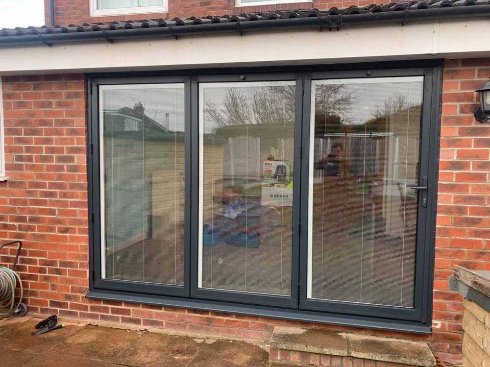 After: grey aluminium bi-fold doors