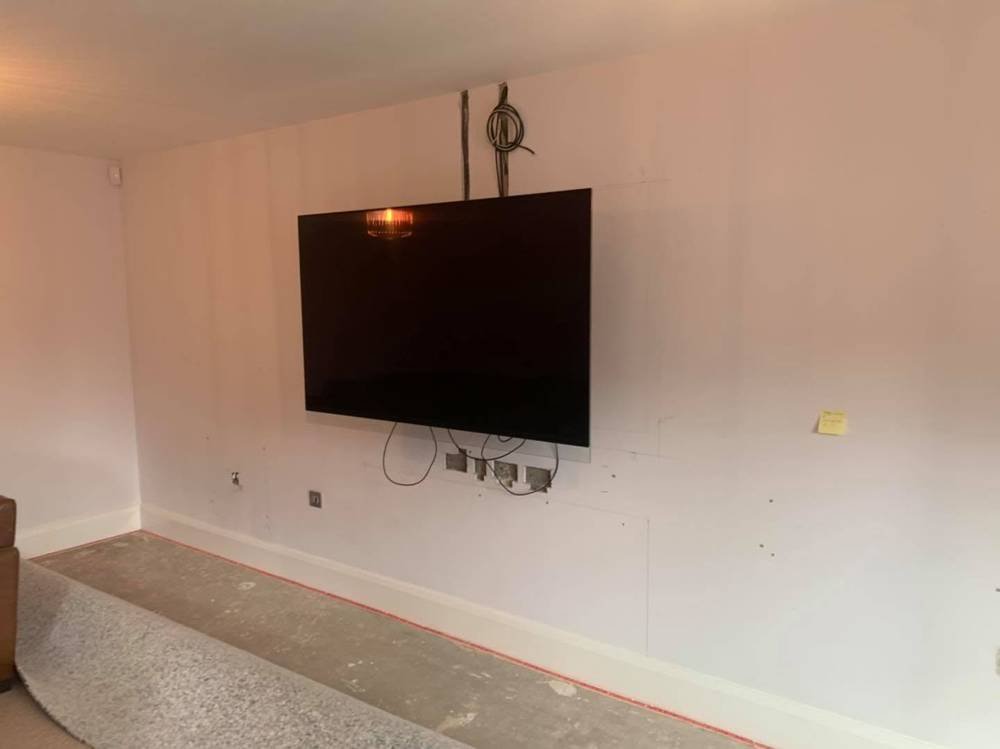 Before: plain wall with wall-mounted TV